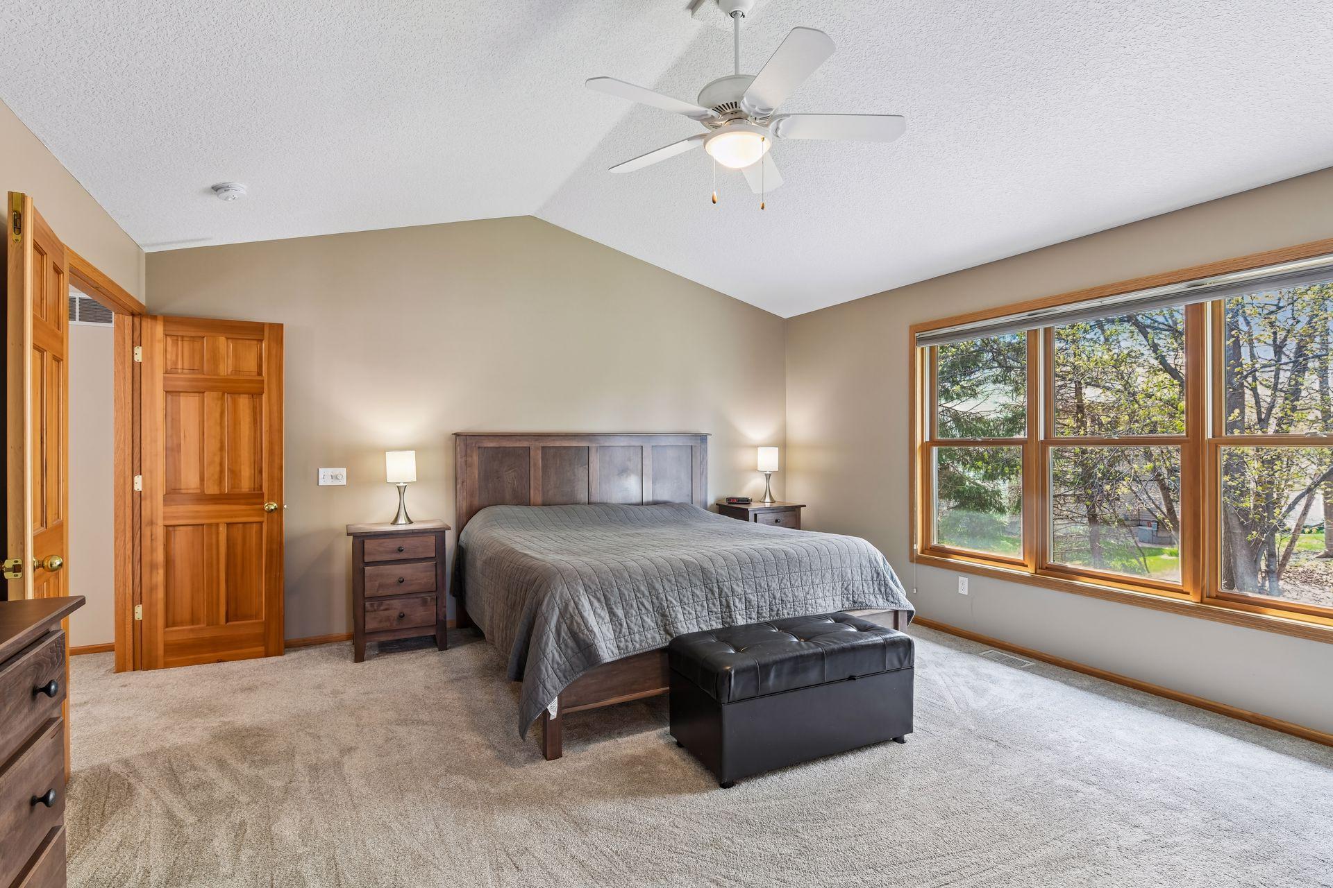 A large primary bedroom is highlighted by vaulted ceilings