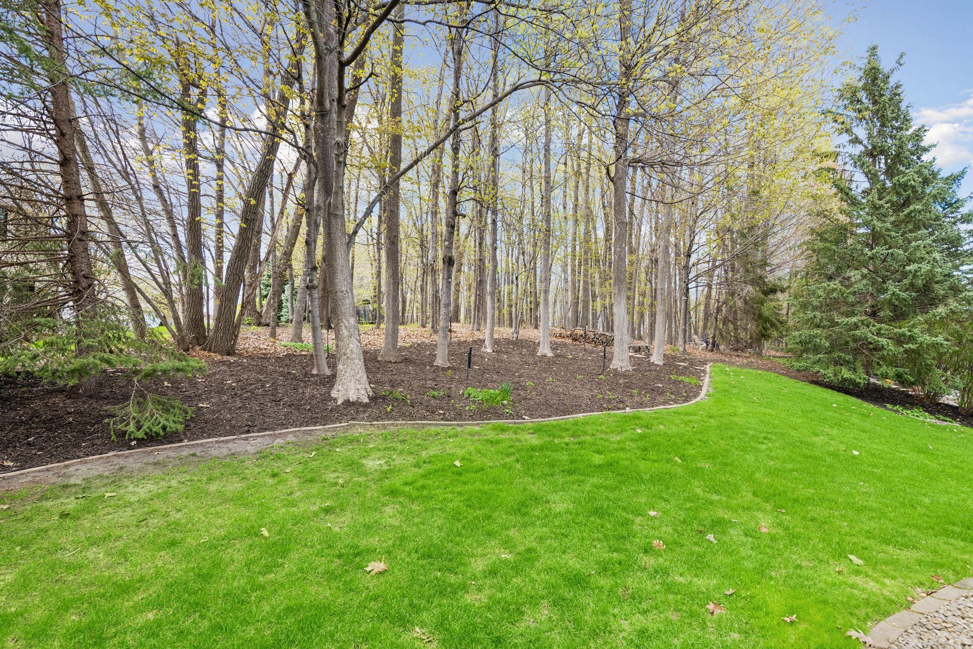 Thoughtfully designed landscaping includes concrete curbing and an in-ground sprinkler system for easy maintenance.