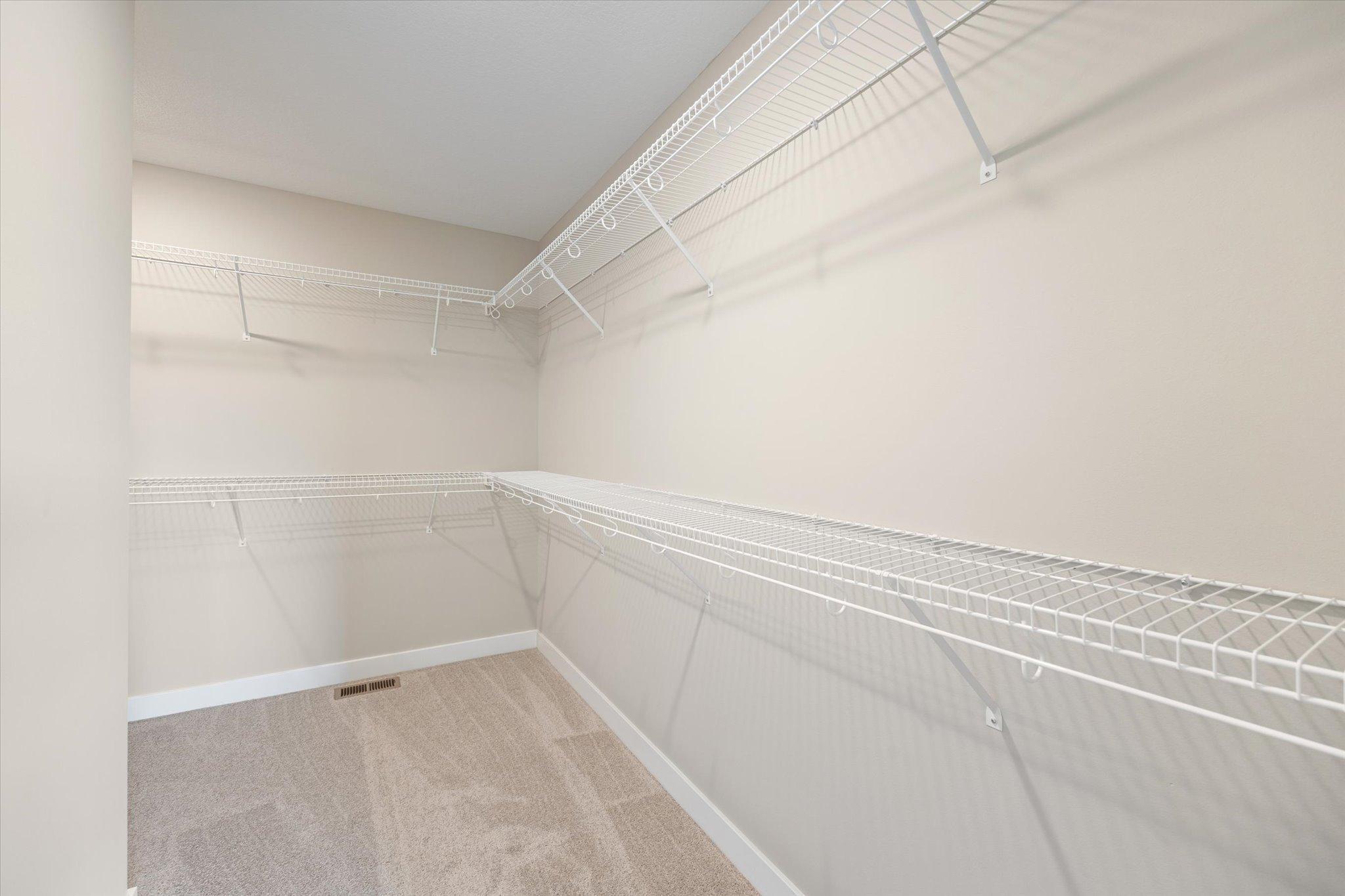 This L shaped owner's closet is amazing!