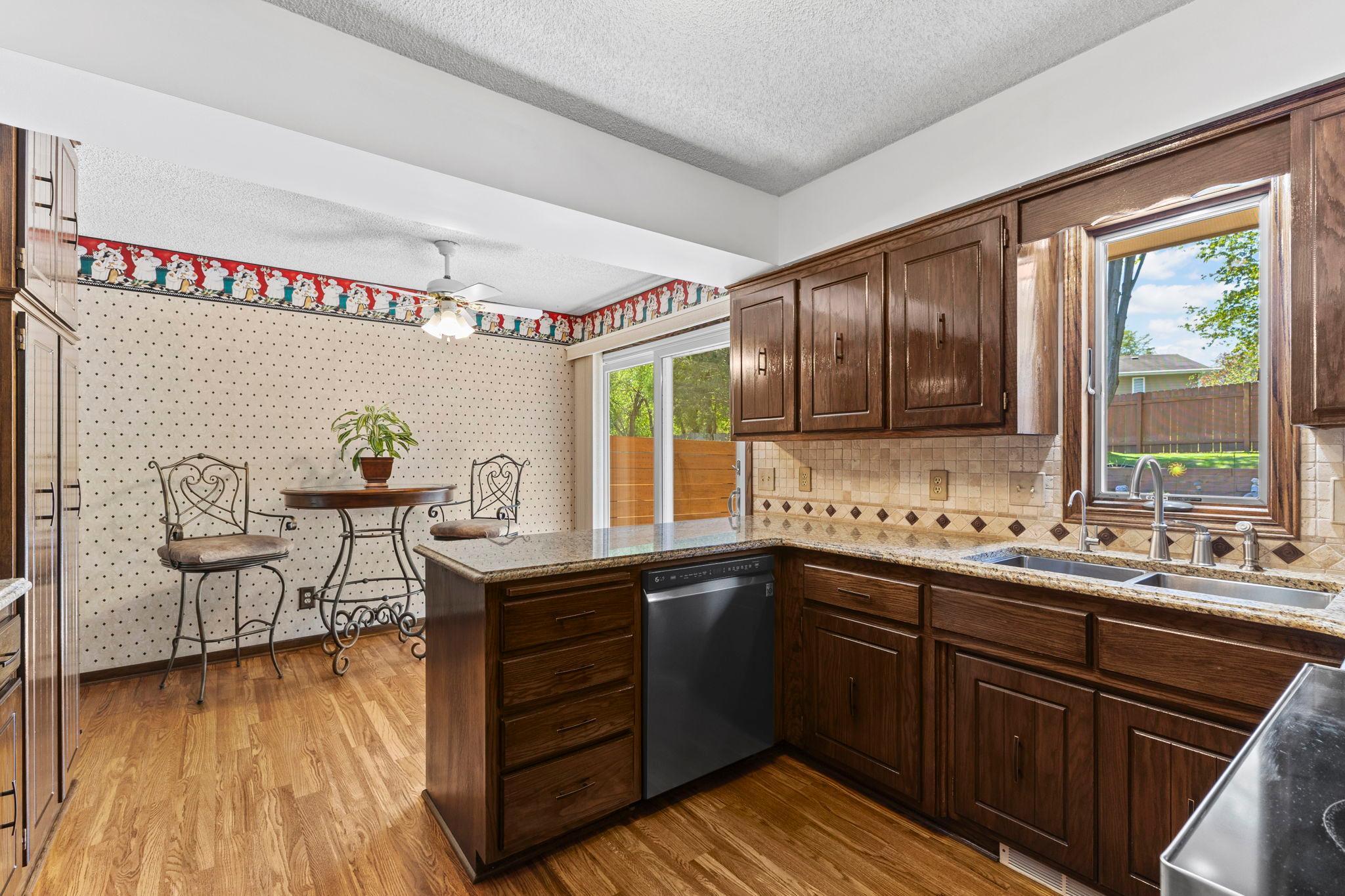 With new SS appliances, refinished hardwood floors, a gorgeous tile backsplash & granite countertops!