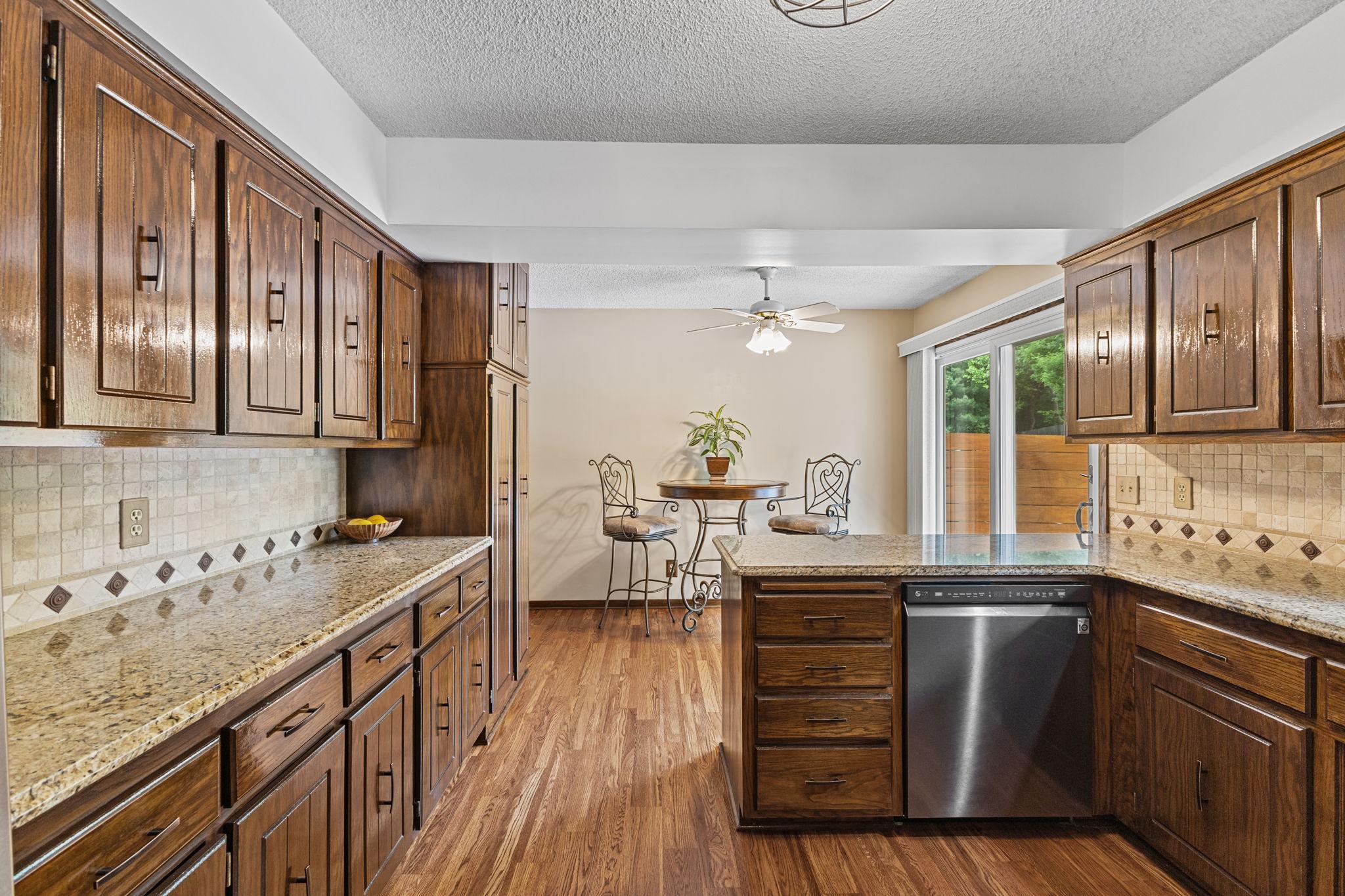 With gorgeous new SS appliances, granite countertops & tile backsplash!