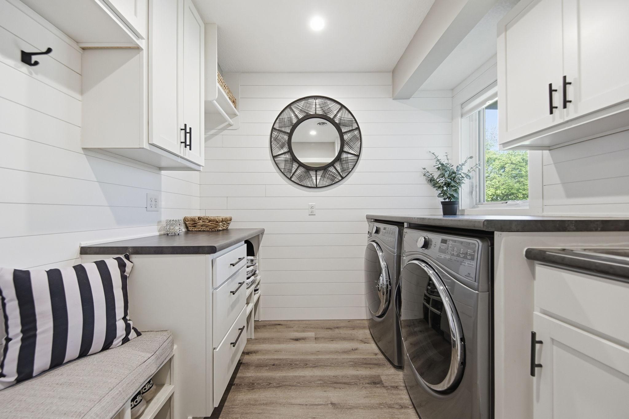 Large laundry room with custom built-ins and an extra locker