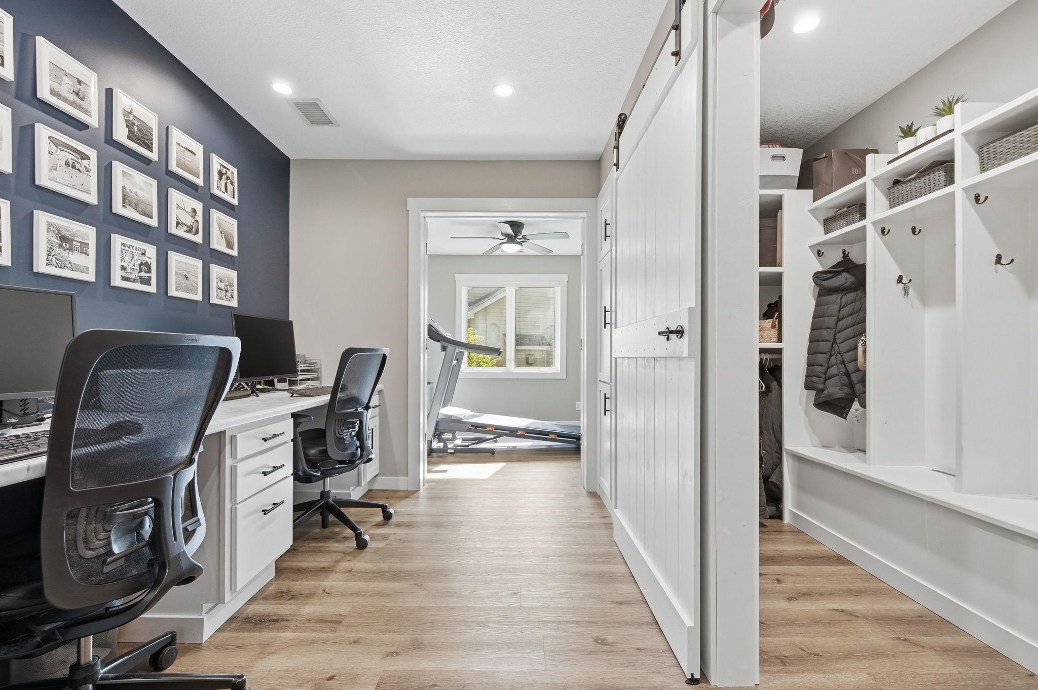 A wonderful barn door reveals the large custom built-in locker room with four locker areas