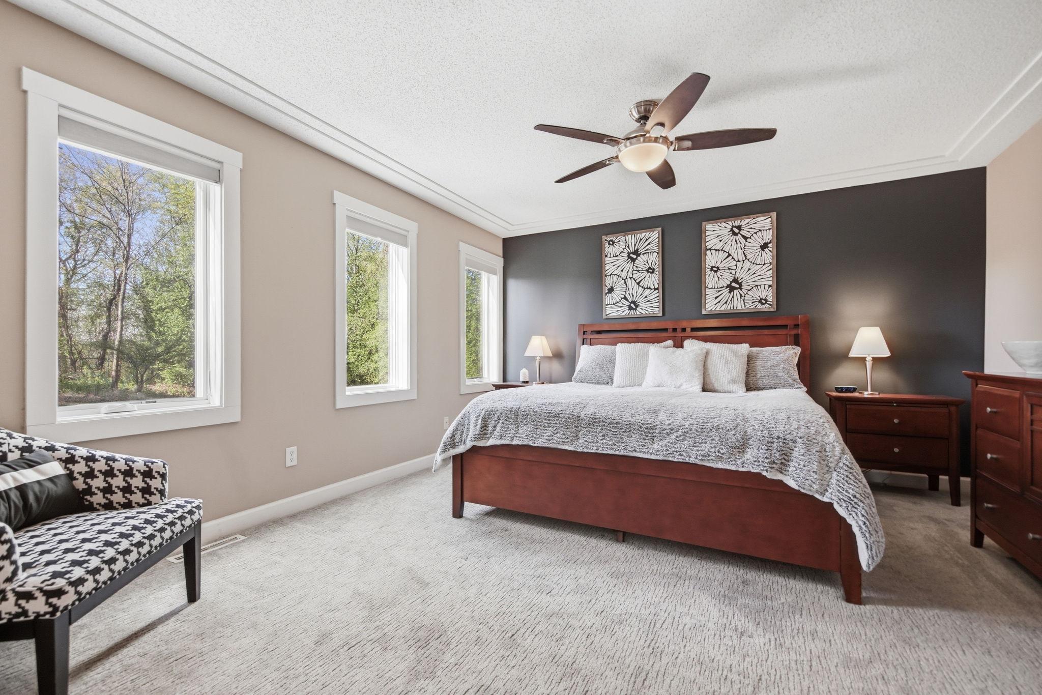 Enjoy the windows and accent wall under a tray ceiling