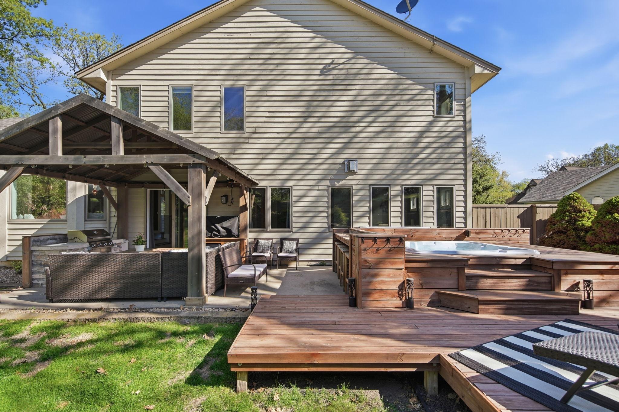 Permanent wood pergola with metal roof and built-in grill station