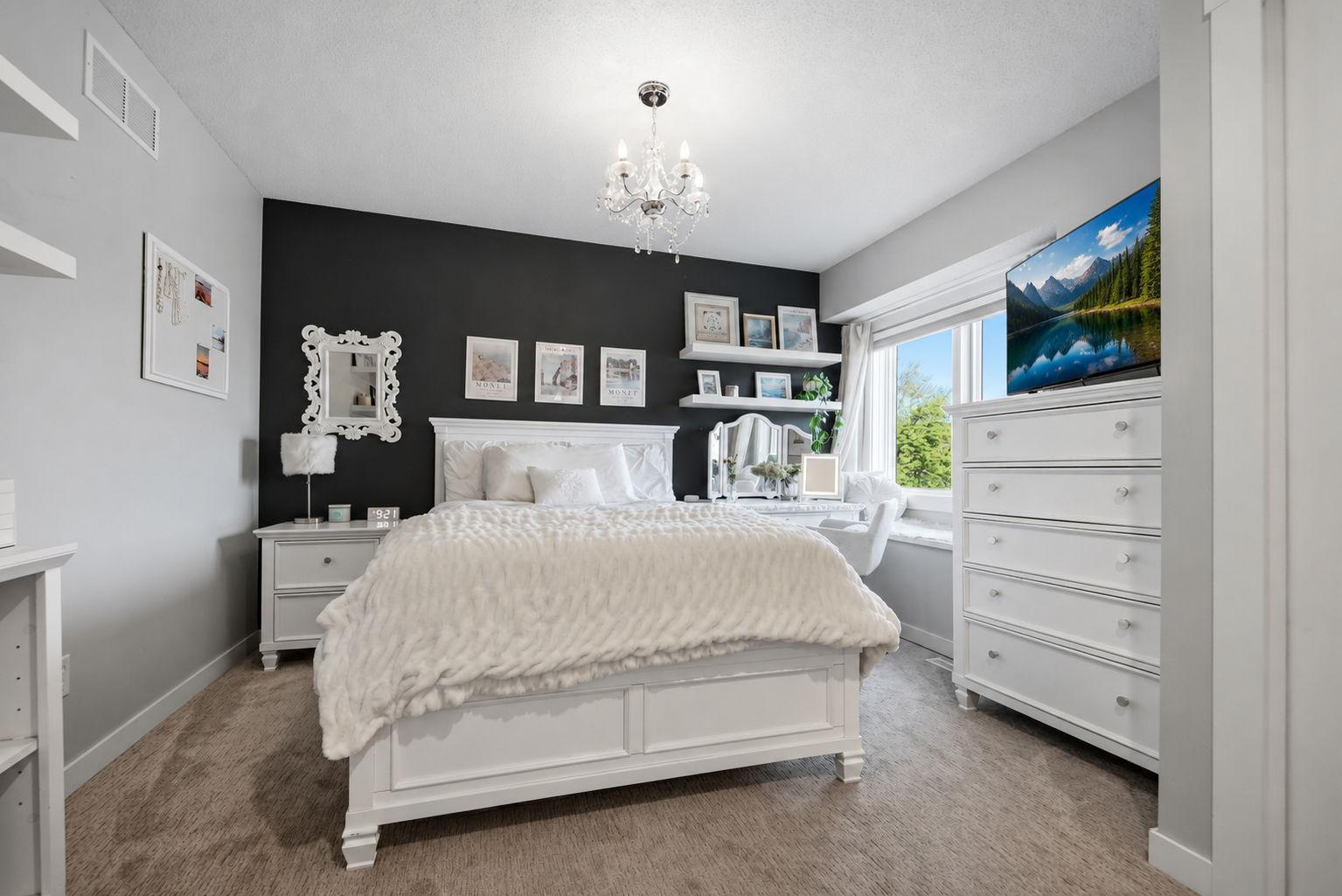 A stunning Upper-level third bedroom with excellent lighting and large window