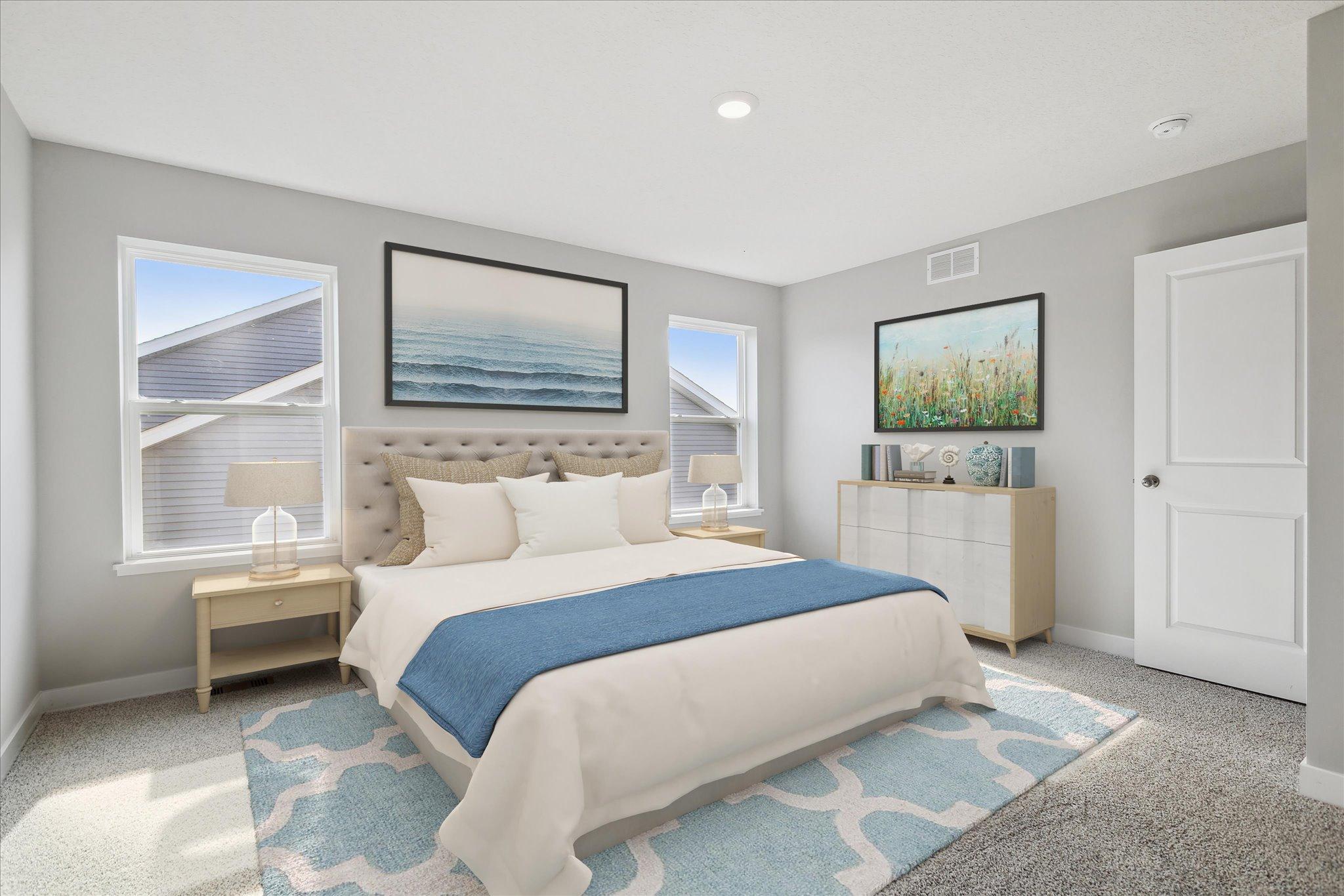 The primary bedroom on the upper level with an ensuite bathroom and large closet!