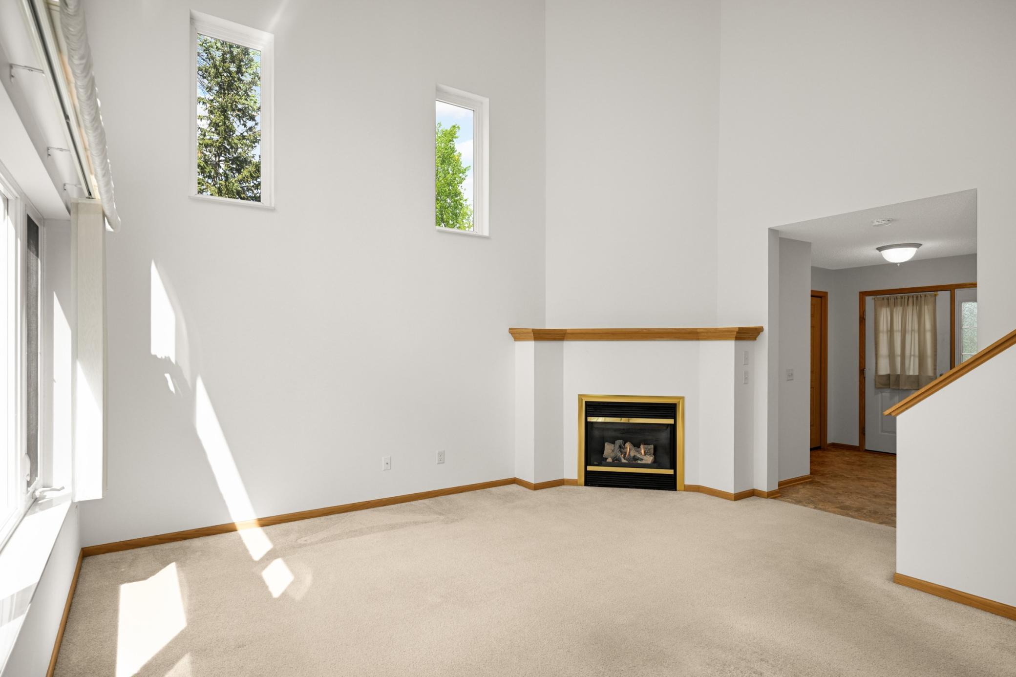 The living room features a corner gas fireplace