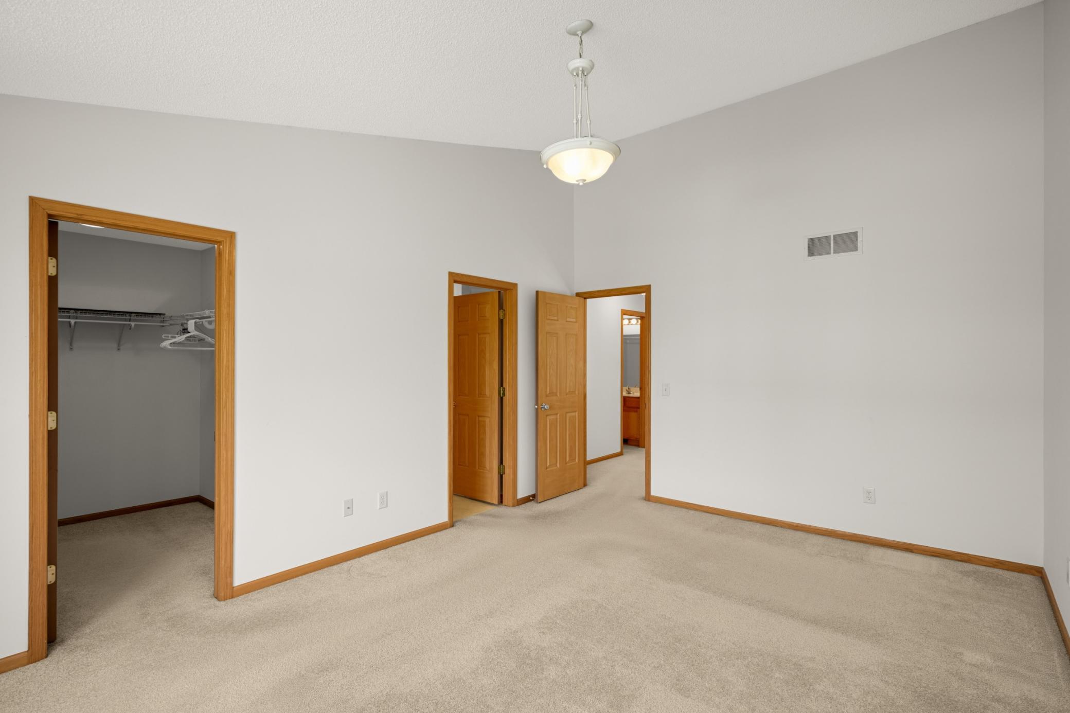 Primary bedroom includes an en suite bathroom and walk-in closet