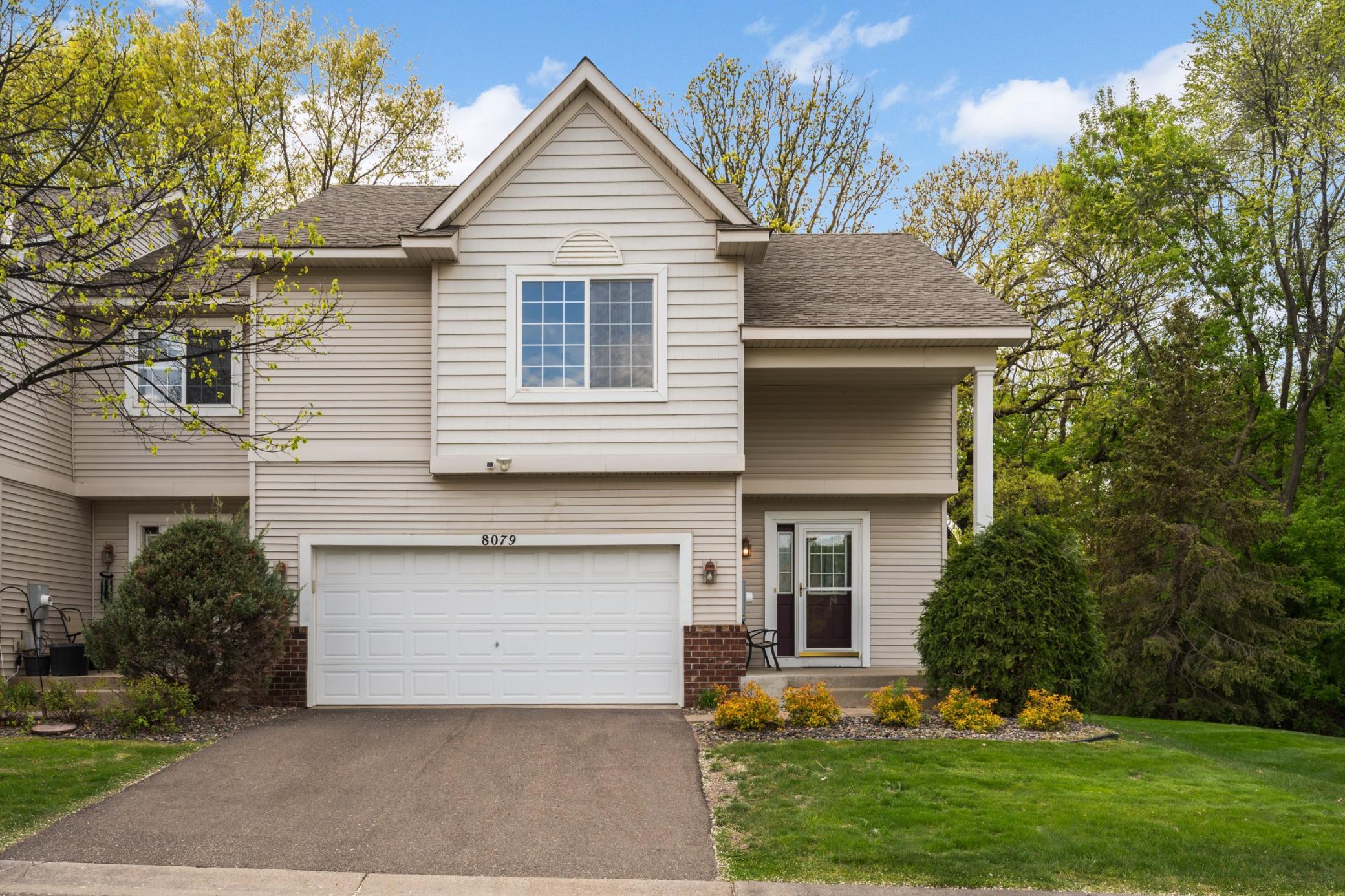 Gorgeous end-unit townhome surrounded by trees a convenient two-car garage