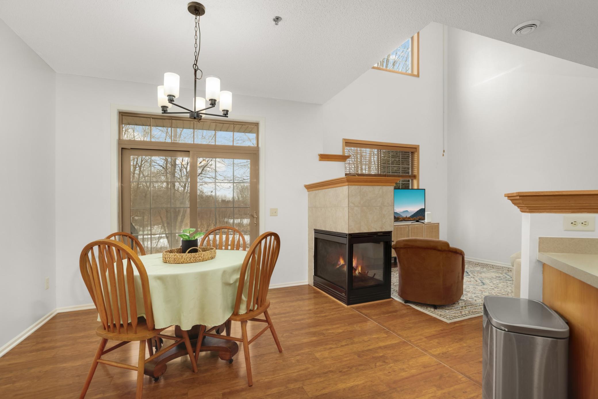 Three sided fireplace enjoyed from all main level rooms