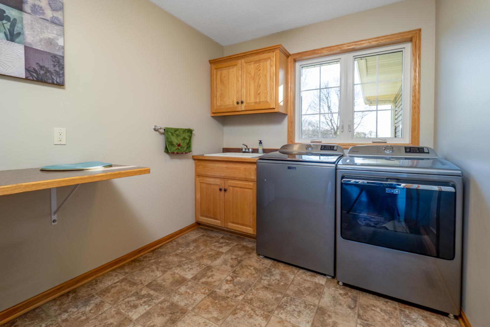 Main floor laundry/mudroom with built-in laundry sink