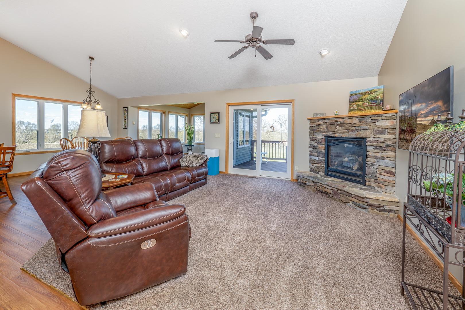 View of living room with patio doors that open to the deck