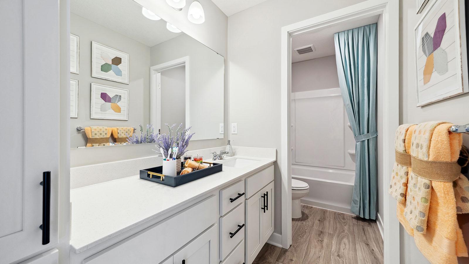 The main bath upstairs has two sinks and a separate room for shower and toilet. Photo of model, colors an finishes may vary.