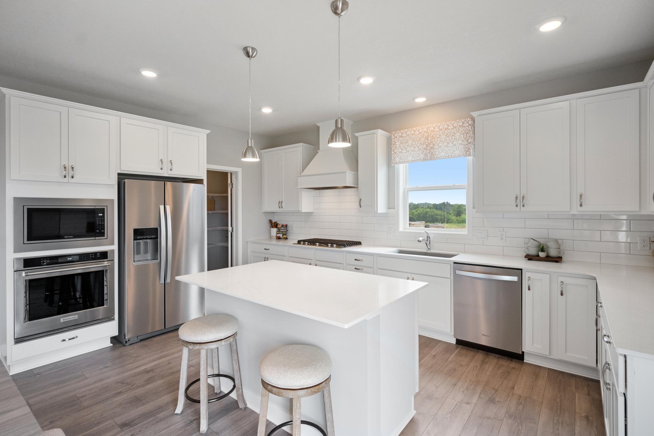 Soft close doors and drawers, undermount sink, and a kitchen window!! Photo of model home, colors and finishes may vary.