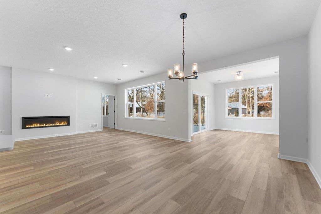 LVP and so many windows grace the great room/sunroom- representational photo- finishes vary