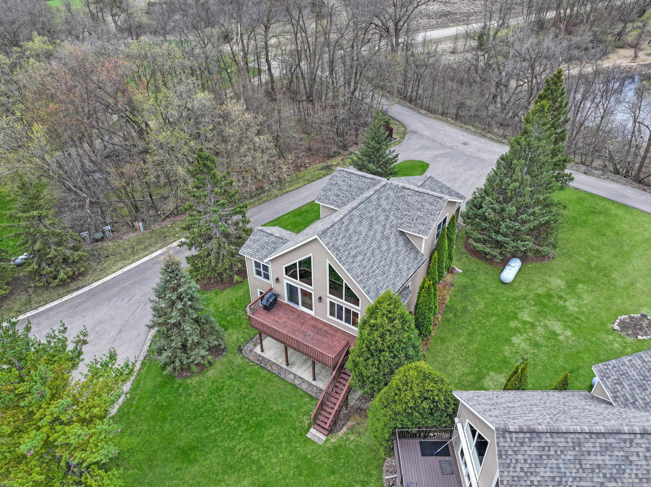Surrounded by woods and a pond - this lake home has the advantages of both privacy and lake access