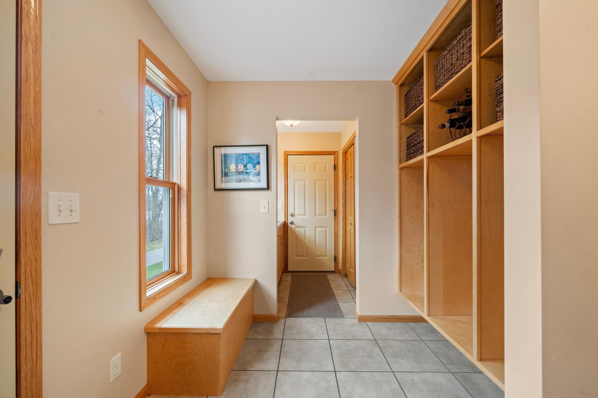 Large Foyer / Mudroom with entrances to the garage and outside