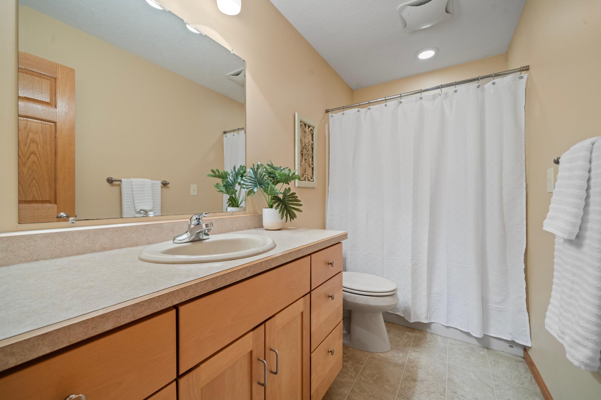 Upper level bathroom with a tub/shower combination