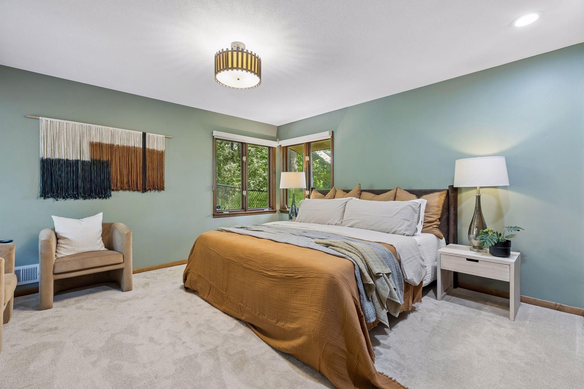 Primary bedroom with newer carpet and roller shades.