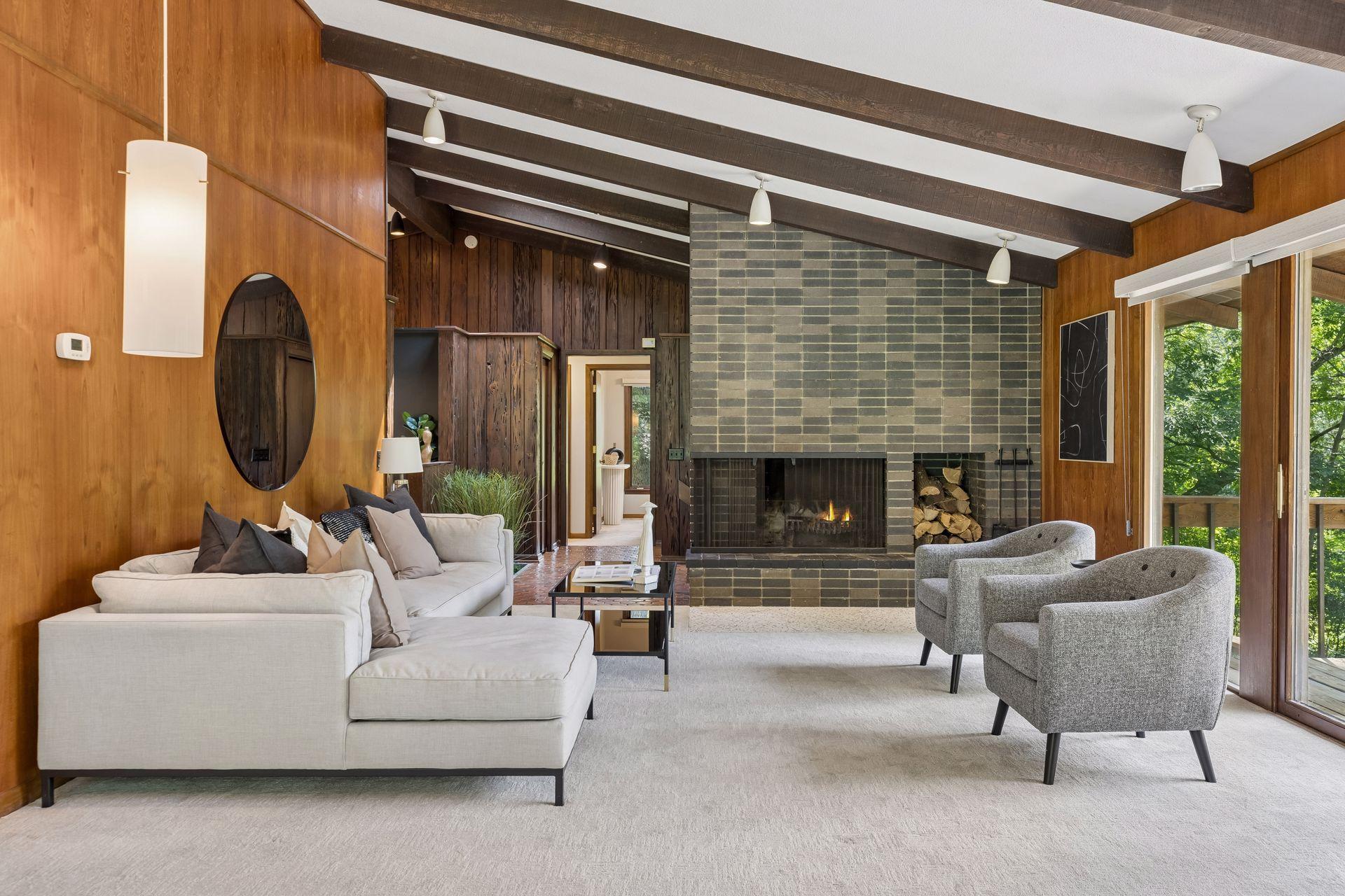 Living room with handsome brick surround woodburning fireplace.