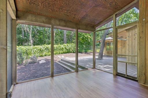 Full view screened porch looks over backyard.