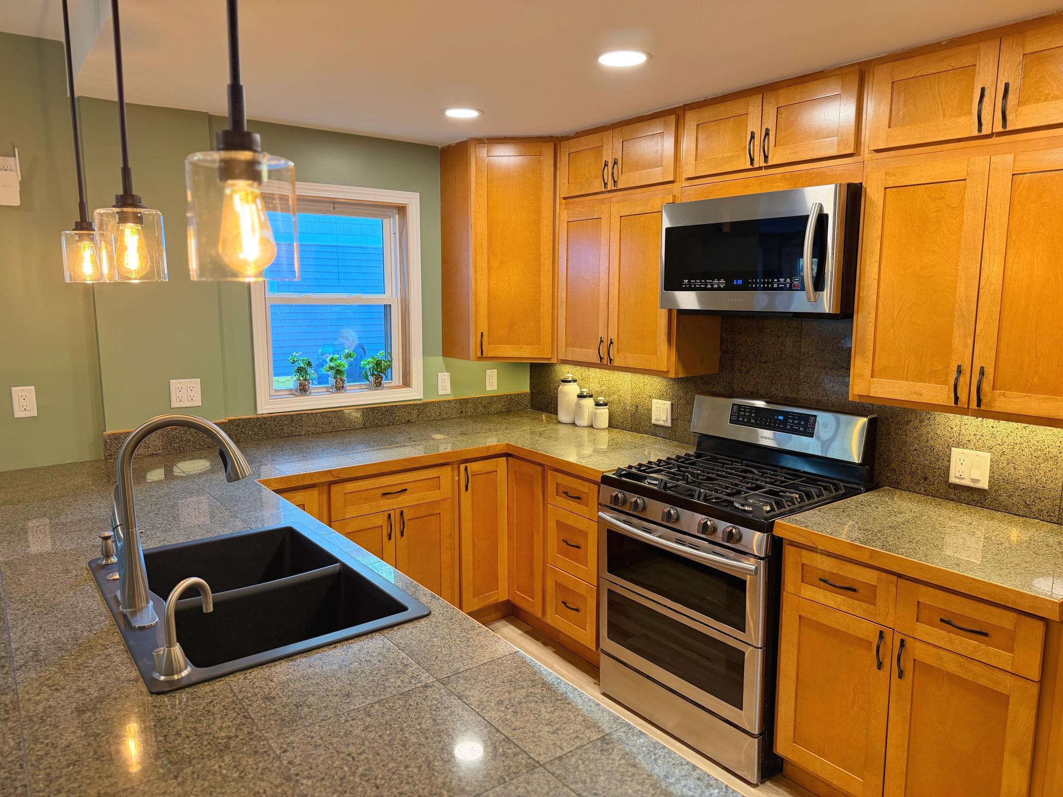 Kitchen with new cabinet fronts and light fixtures