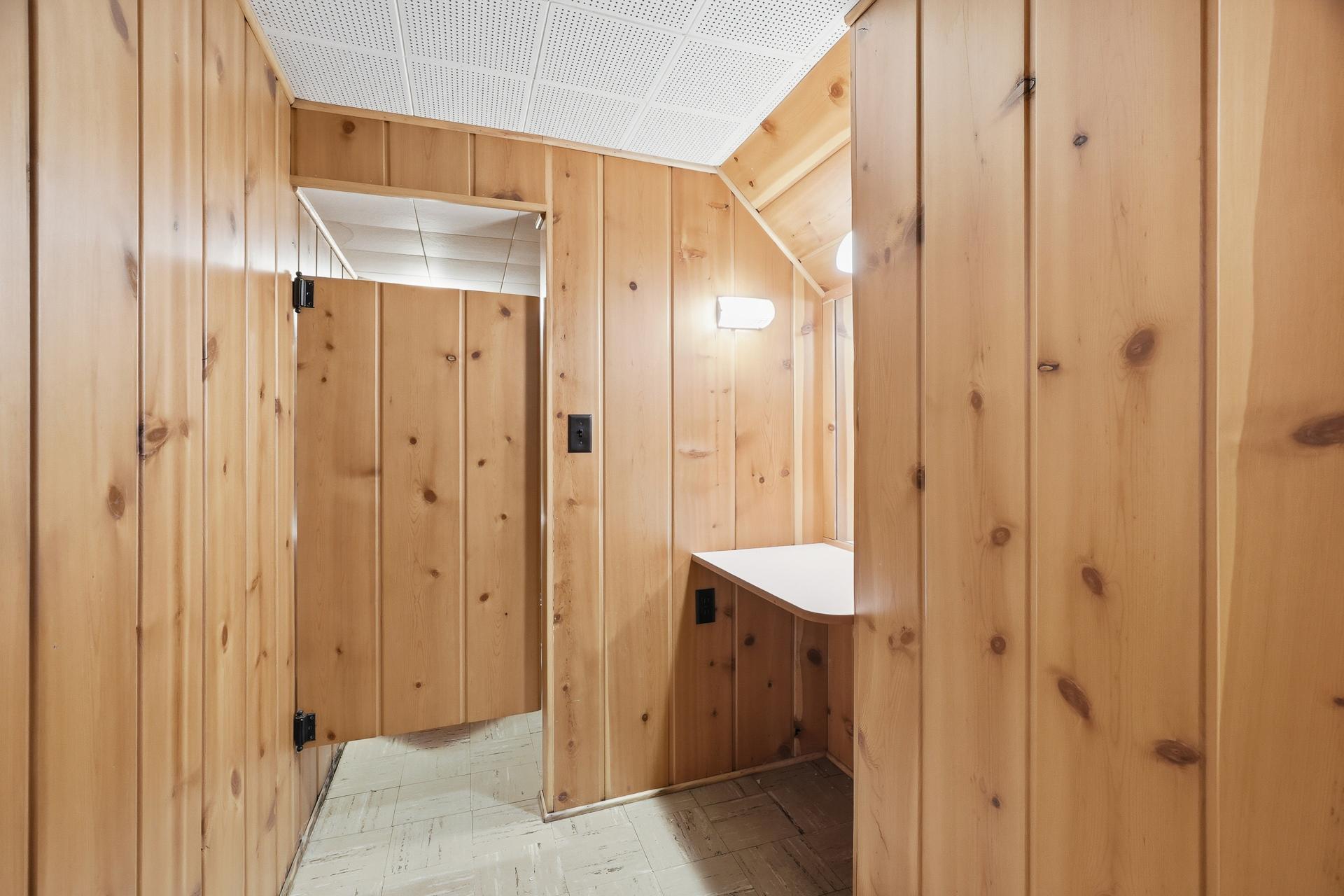Lower level half bath with swing door access to...