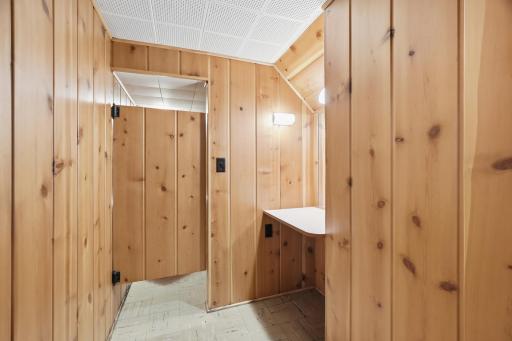 Lower level half bath with swing door access to...