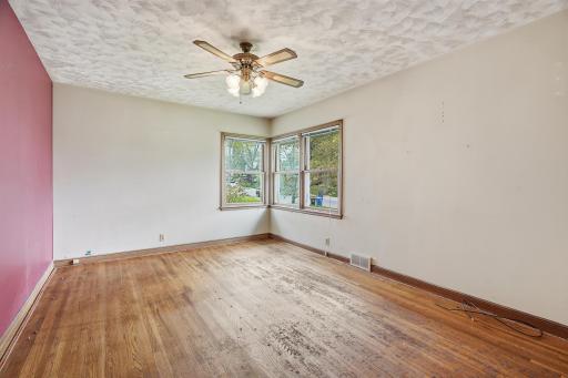 11x15 primary bedroom with original oak hardwood floors.