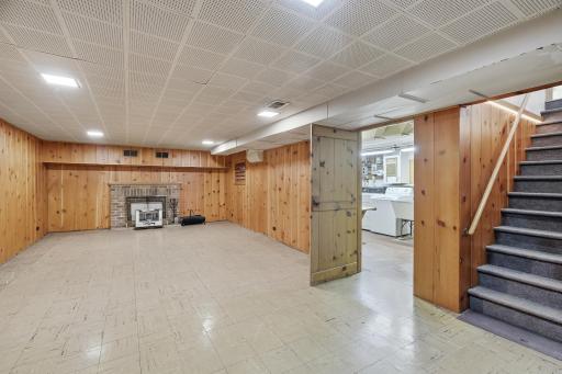 Lower level 13.5x11 Family Room with knotty pine paneling. Wood-burning fireplace has not been used in years, and not deemed to be in working order.
