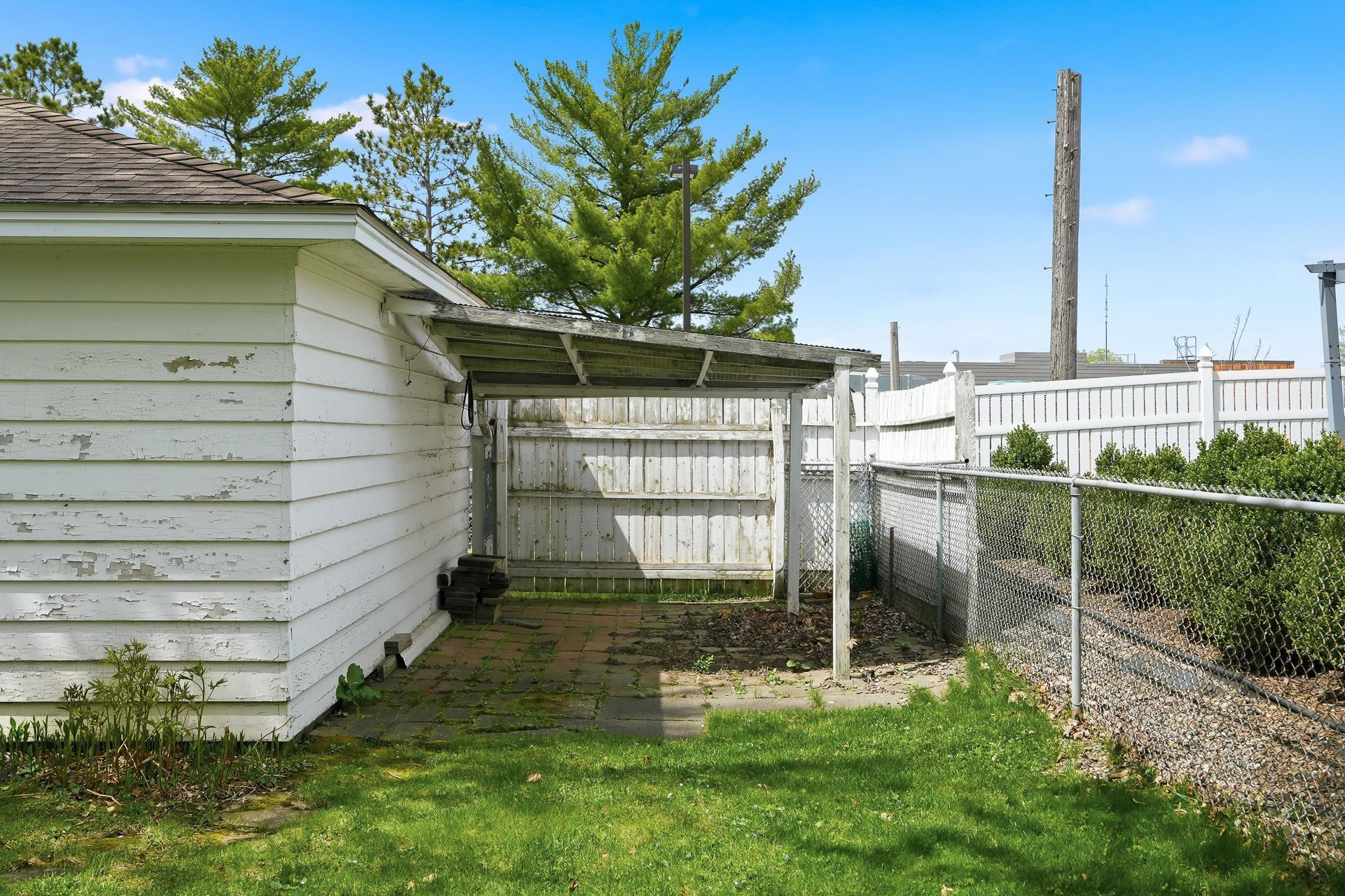 Storage area behind garage has gate access.