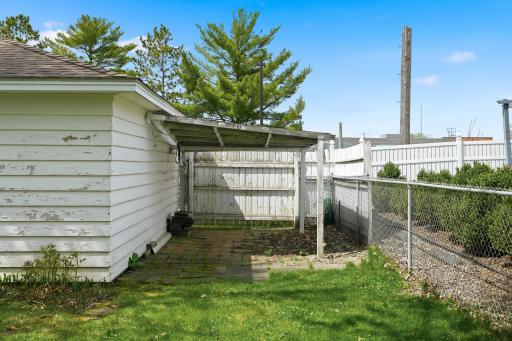 Storage area behind garage has gate access.