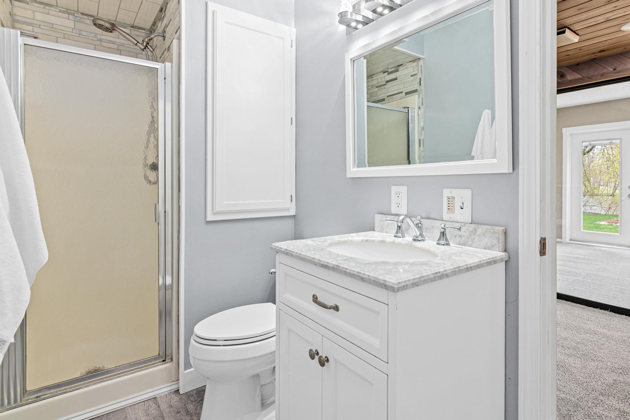 Convenient ¾ bathroom located on the lower level, ideal for guests and everyday use. Thoughtfully positioned to serve nearby living and recreation spaces.