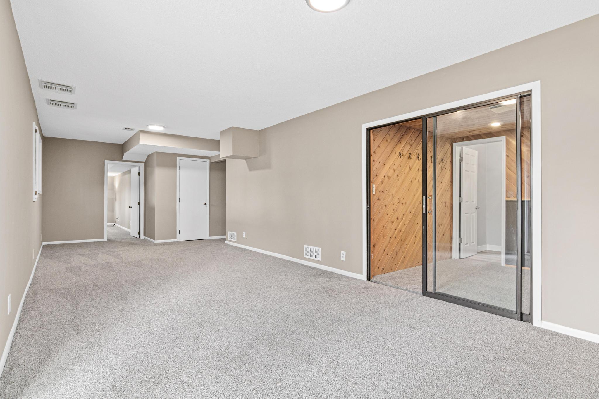 Expansive lower-level family room designed as a hub for entertainment and recreation.