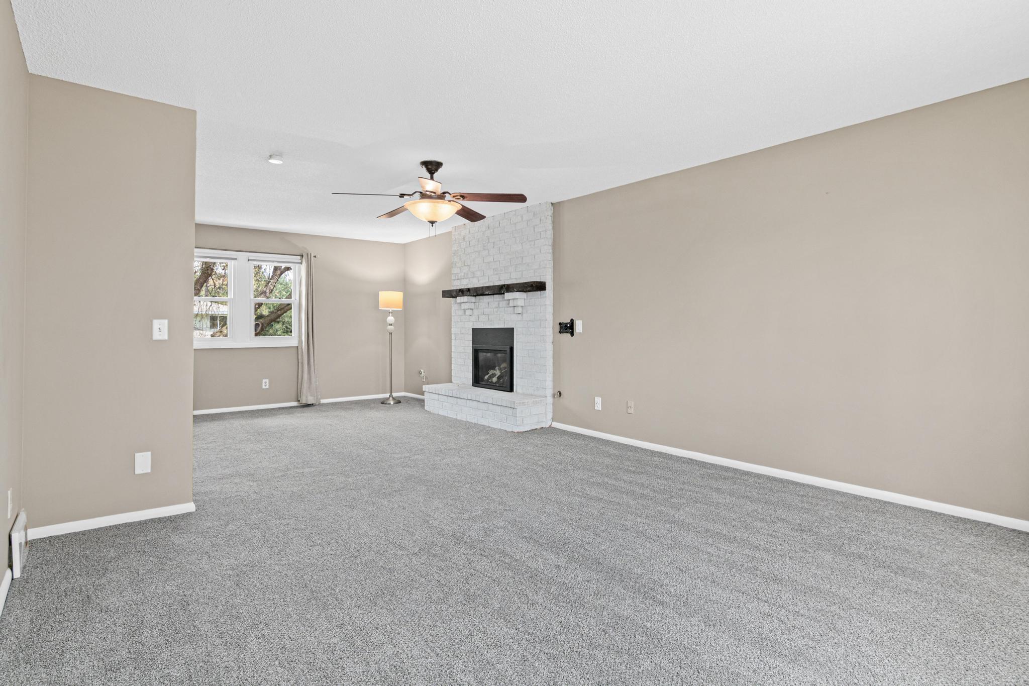 Expansive primary bedroom offers view to the front yard and back yard. Gas fireplace to set a cozy mood in the winter.