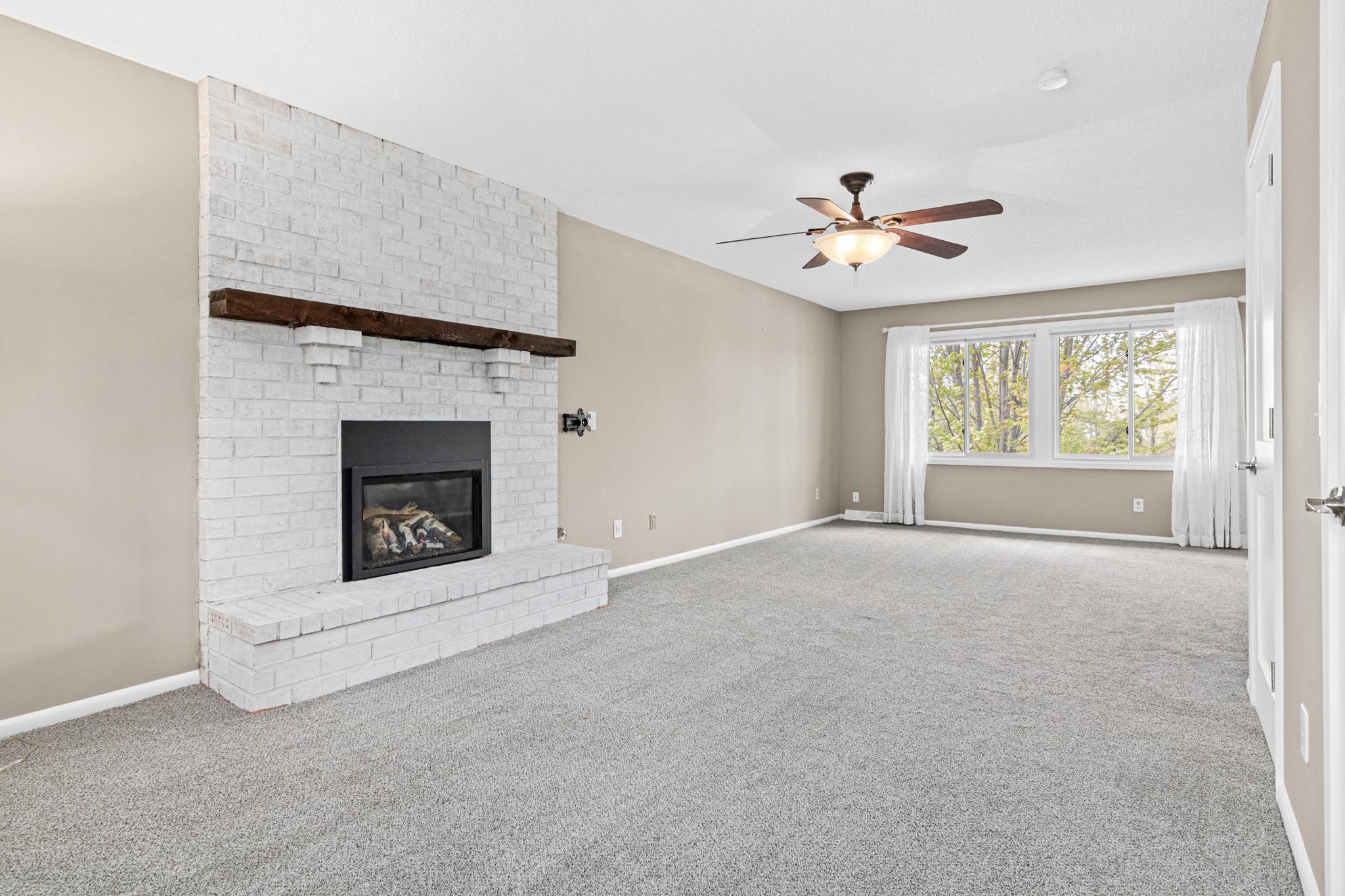 Spacious owner’s suite offering a peaceful retreat with breathtaking lake views. Gas fireplace is the perfect place to snuggle up during winter evenings at home.