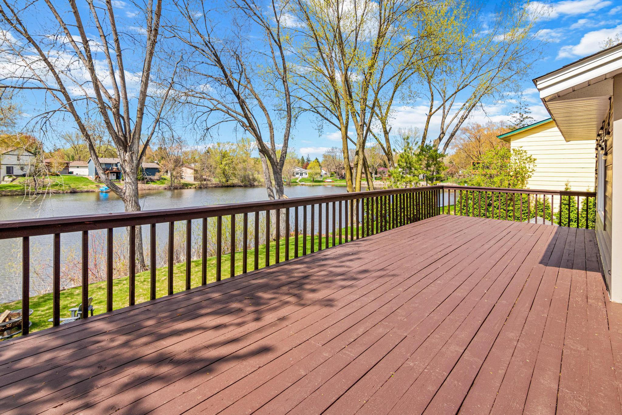 Oversized deck overlooking Evergreen Ponds, offering stunning views and an ideal setting for outdoor dining and entertaining.