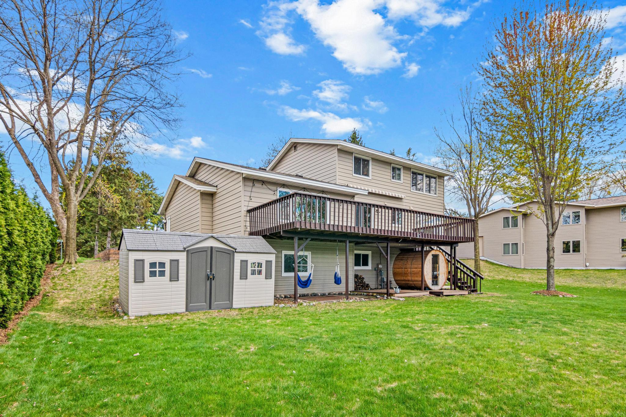 The large, flat backyard provides plenty of space for activities, games, and year-round enjoyment of the lakeside setting.