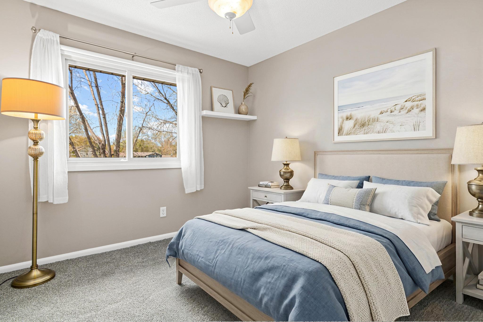 One of three bedrooms located upstairs with views to the lake. New carpet and paint. Virtually staged.