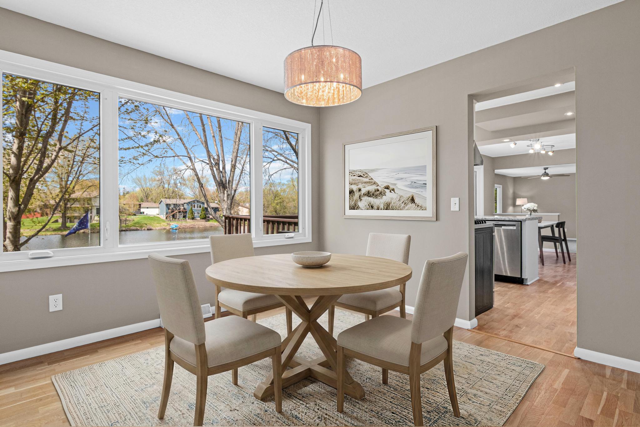 Elegant formal dining room positioned to capture scenic views of the lake. Perfectly suited for hosting dinner parties or holiday gatherings, it offers a warm and refined atmosphere. Virtually staged.