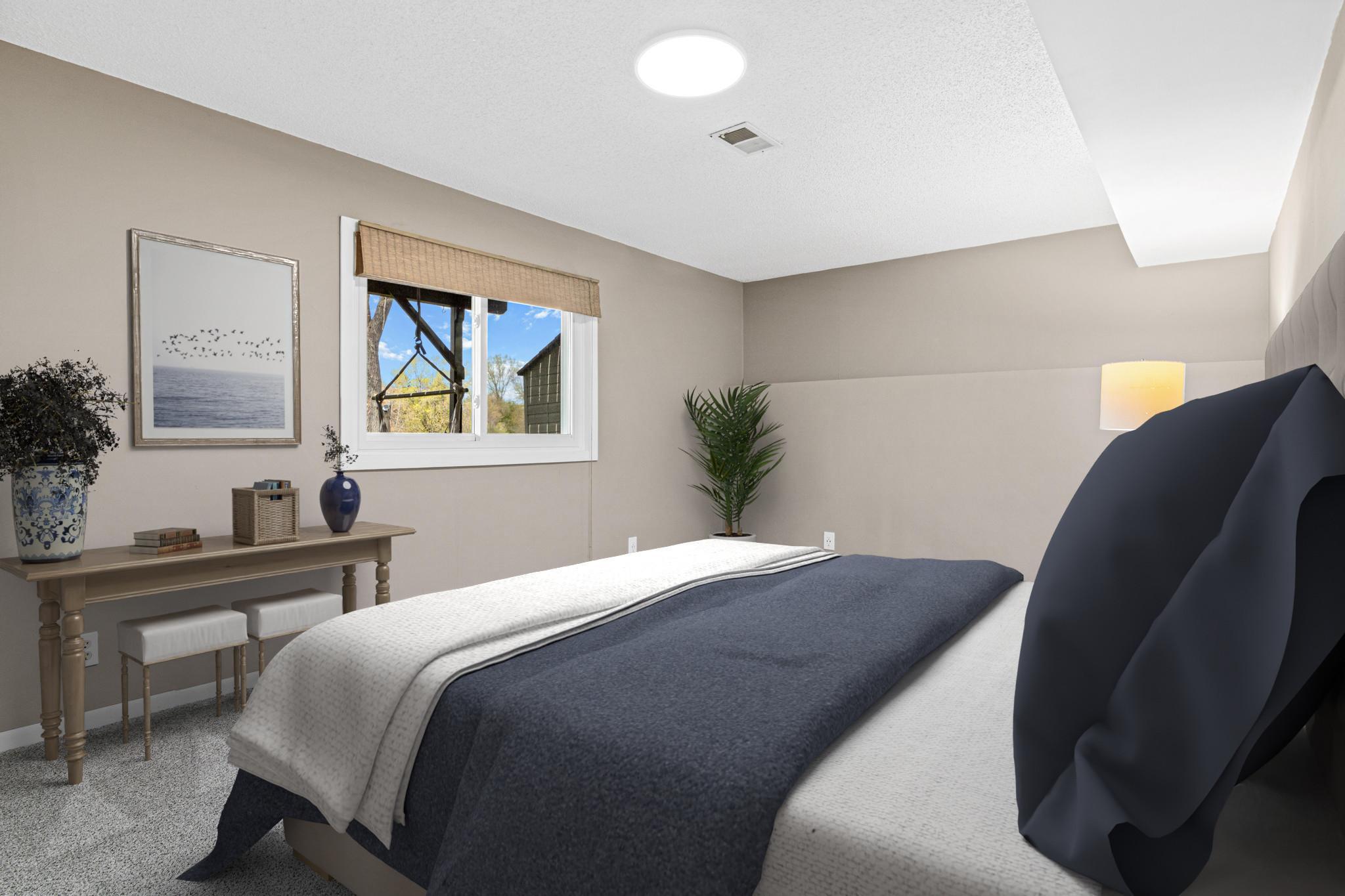 Private lower-level bedroom that offers a quiet and comfortable space for guests. Ideal for extended stays or multi-generational living arrangements. Visually staged.