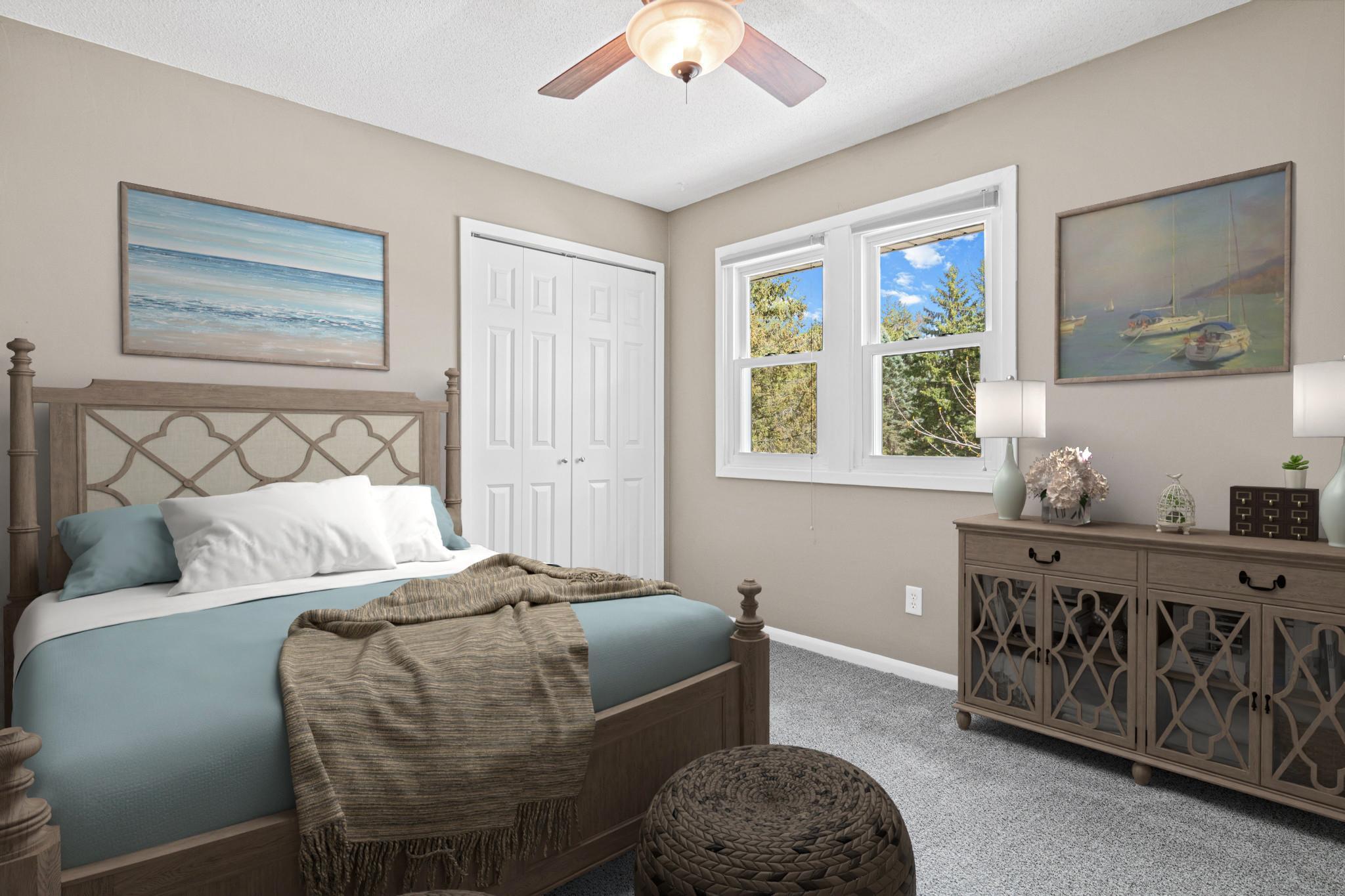 One of three bedrooms upstairs with new carpet and paint. Visually staged.