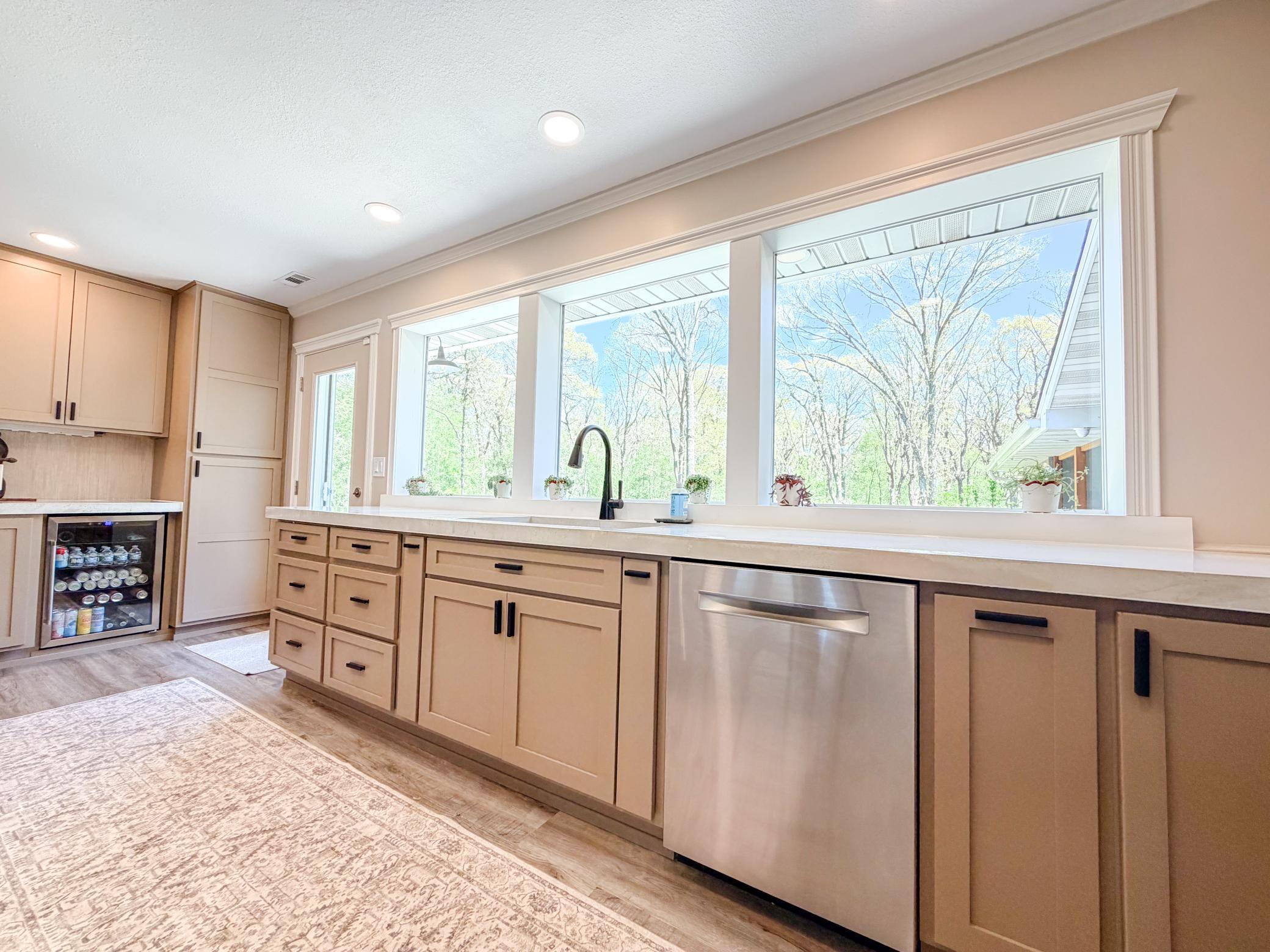 Massive windows overlooking backyard and surrounding woods