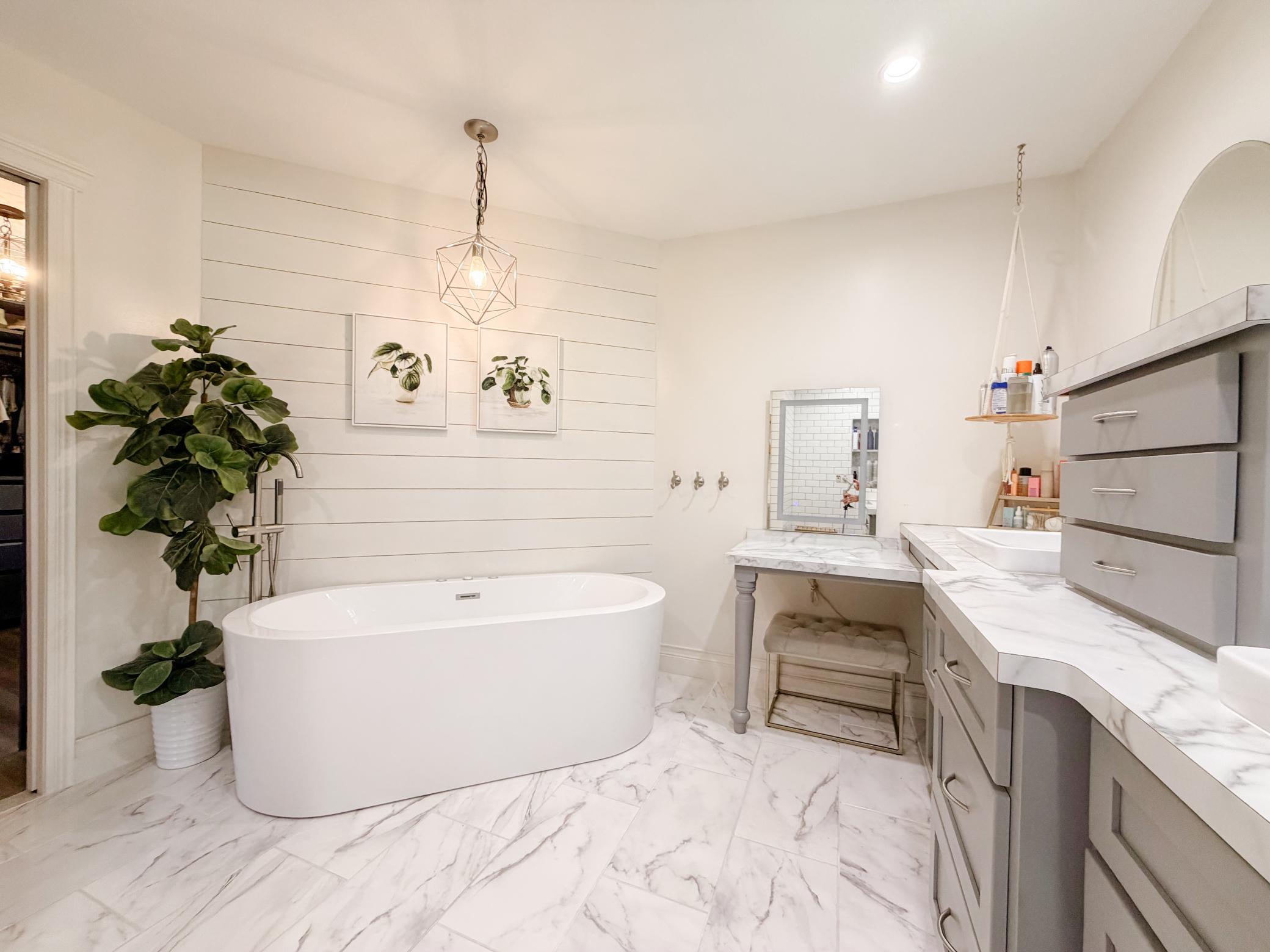 Primary suite full bath with jetted and air freestanding tub, vanity area with built in jewelry and tool drawers