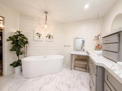 Primary suite full bath with jetted and air freestanding tub, vanity area with built in jewelry and tool drawers