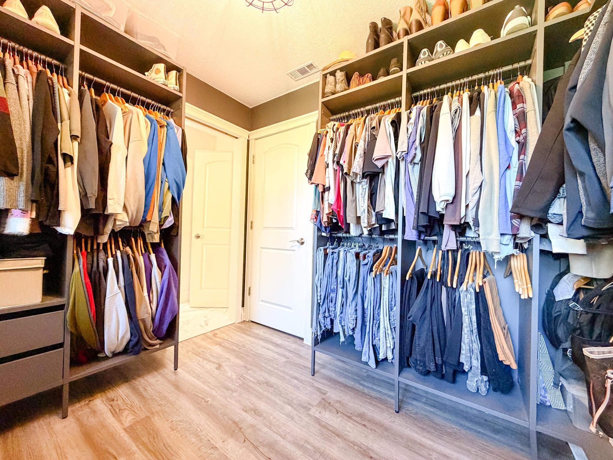 Door to primary bathroom and extra closet