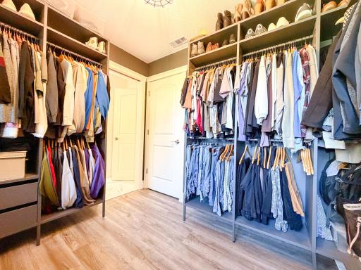 Door to primary bathroom and extra closet