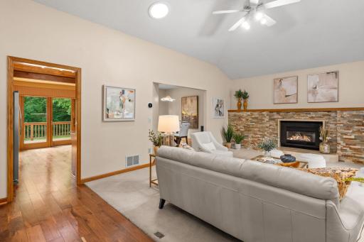 Open-concept main level seamlessly connecting the vaulted living room to the formal dining space and kitchen.