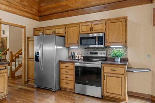 Modern convenience meets classic design with stainless steel appliances and custom tile backsplash.